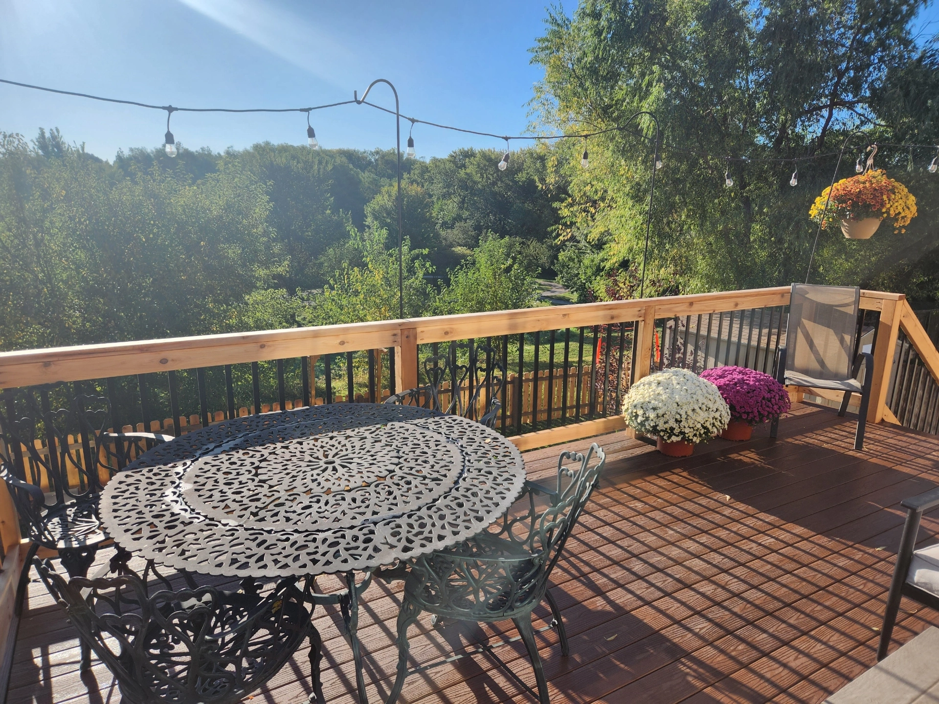 Deck with dining table chairs and flowers
